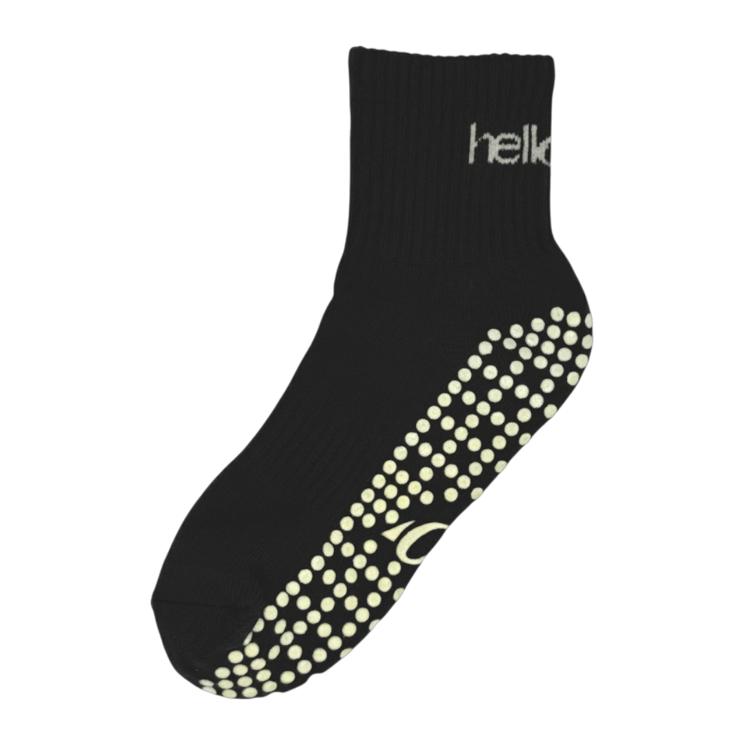 Pair of black cotton-mix pilates socks with reinforced arch support and breathable mesh top, flat lay.