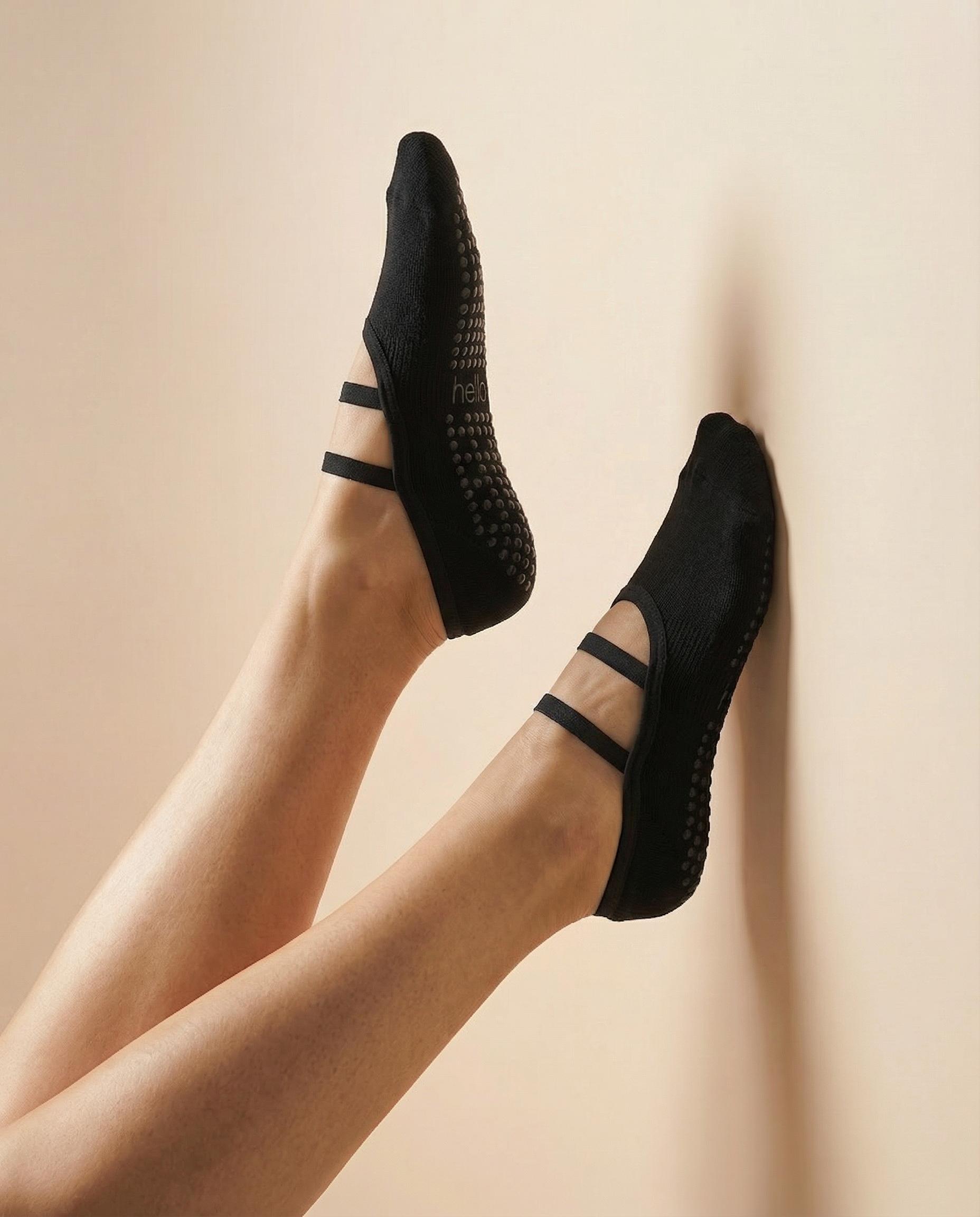 black ballet grip socks against coloured wall