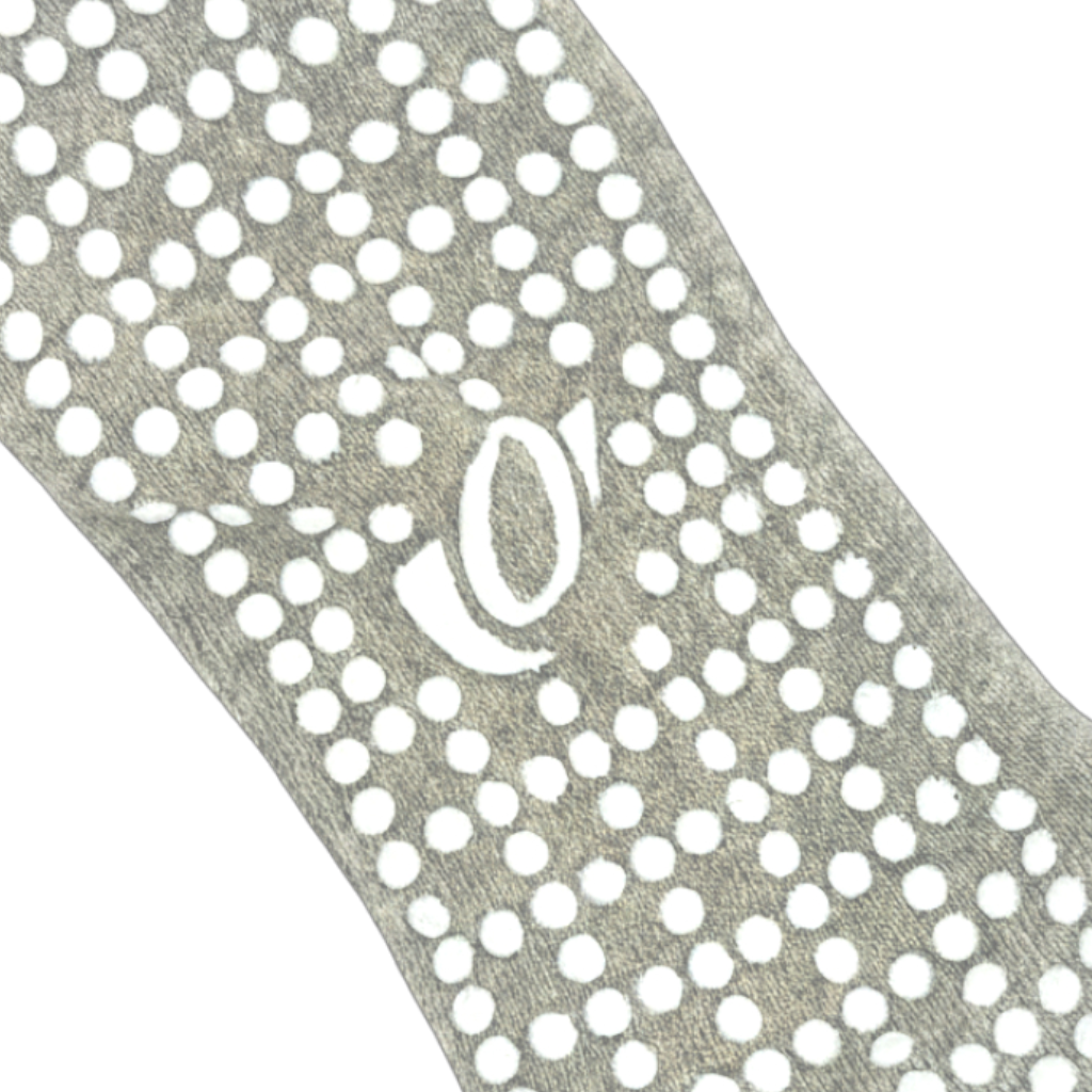 Close-up of hellourr grey pilates socks showing honeycomb silicone grip pattern on the sole for non-slip traction on a reformer.