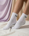 white and black hellourr pilates socks on foot