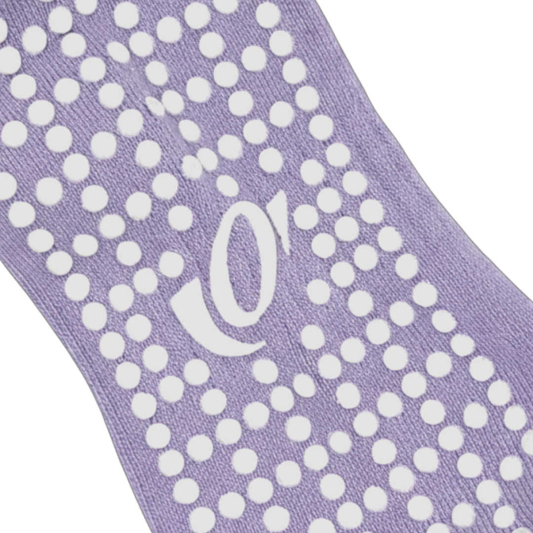 Close-up of hellourr pilates socks showing honeycomb silicone grip pattern on the sole for non-slip traction on a reformer.