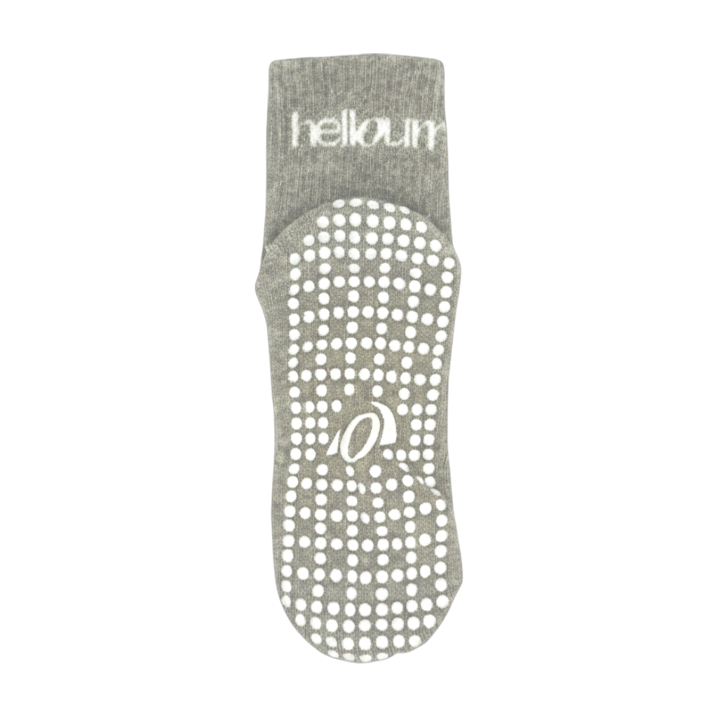 Zoomed out view of grey grip socks with full grip and branding sock