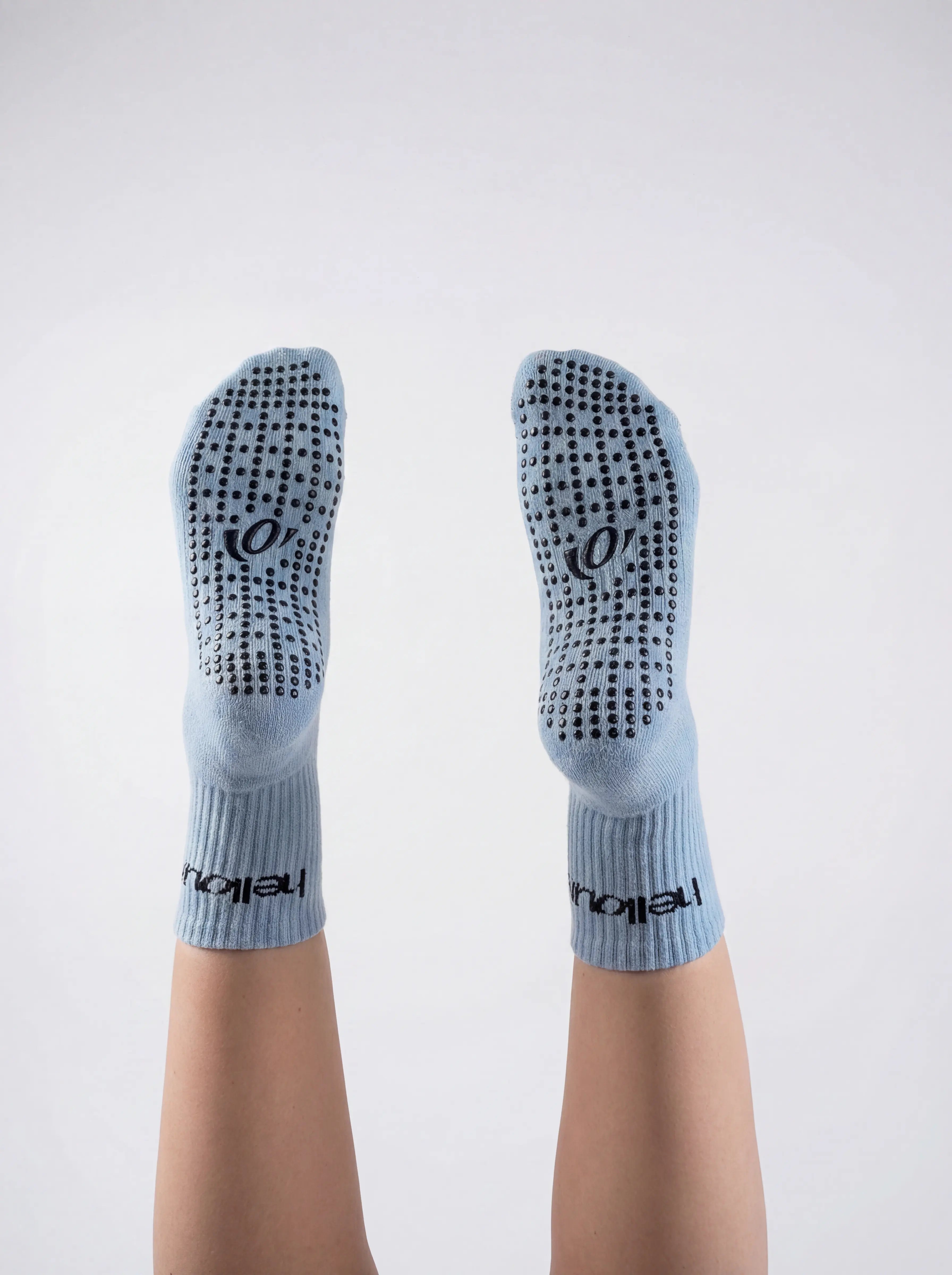 Blue socks with non-slip texture on a white background