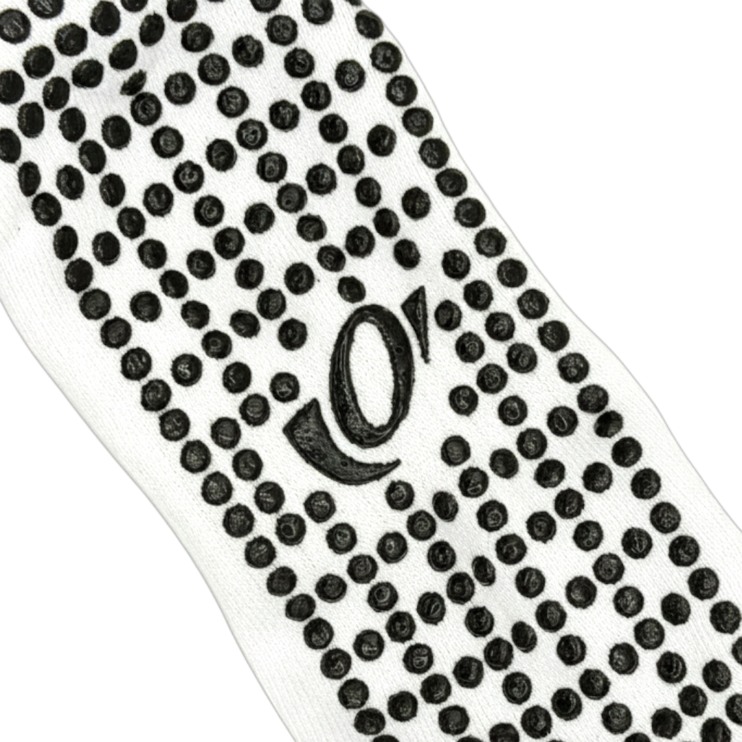 Close-up of hellourr pilates socks showing honeycomb silicone grip pattern on the sole for non-slip traction on a reformer.