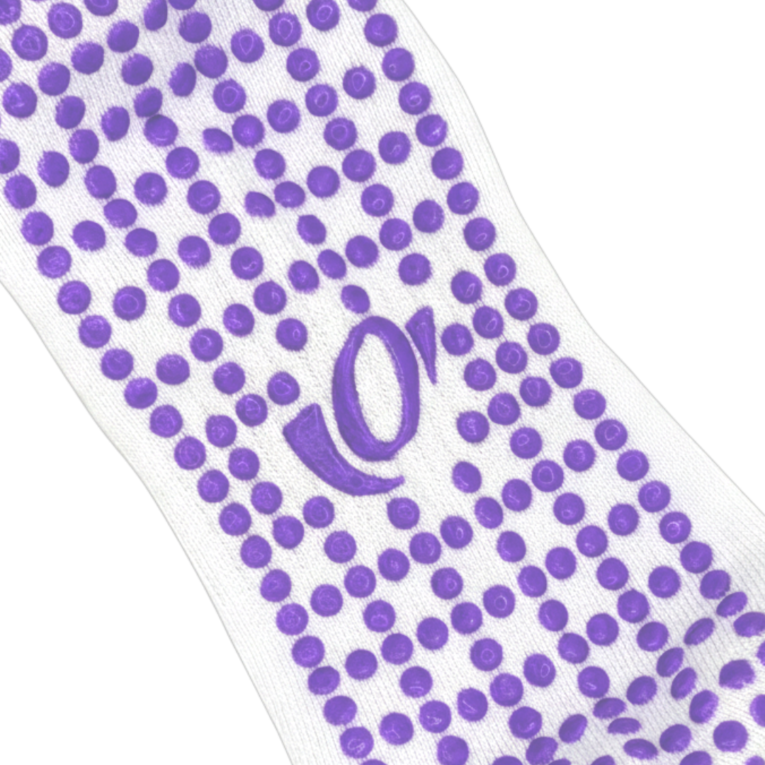 Close-up of hellourr pilates socks showing honeycomb silicone grip pattern on the sole for non-slip traction on a reformer.